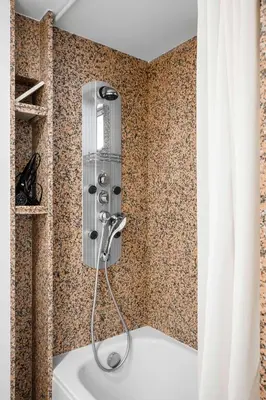 a bath tub with a shower in a bathroom at Best Views from Top Central Cozy 1-Bedroom Flat by Flat Mаnager in Sofia