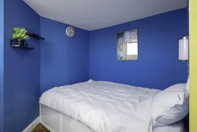 a blue bedroom with a white bed in it at Best Views from Top Central Cozy 1-Bedroom Flat by Flat Mаnager in Sofia