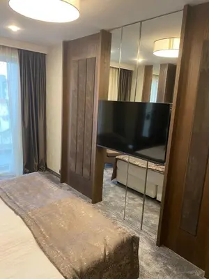 a hotel room with a large flat screen tv at Hotel Royal Plovdiv in Plovdiv