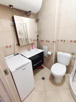 a bathroom with a sink and a toilet and a mirror at Pirin Heights Apartment 200m from SKI ROAD in Bansko