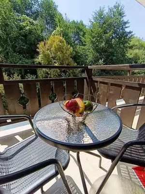 a glass table with a bowl of fruit on a balcony at Luxury flat F218 in Bansko