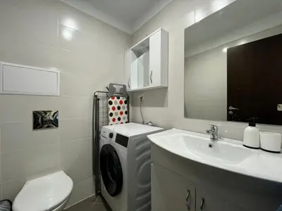 a bathroom with a washing machine and a sink at Luxury flat F218 in Bansko
