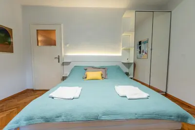 a bedroom with a large bed with two towels on it at Spacious 3-BR Central Retreat in Sofia