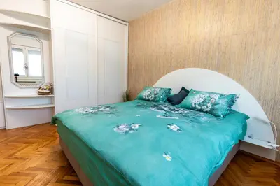 a bedroom with a large bed with blue sheets at Spacious 3-BR Central Retreat in Sofia