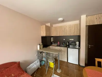 a small kitchen with a table and a counter at Комплекс Свети Георги in Pamporovo