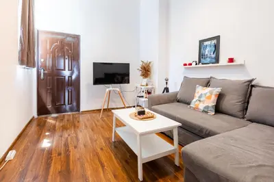 a living room with a couch and a table at Escape in photos in top centre apartment in Sofia