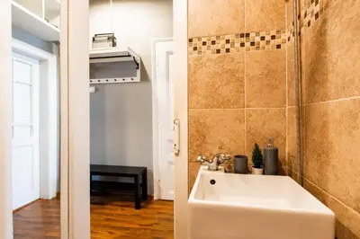a small bathroom with a sink and a shower at Escape in photos in top centre apartment in Sofia