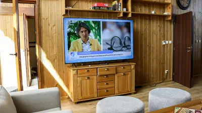 a flat screen tv sitting on a wooden cabinet at Pirin Golf Villa Relax in Razlog
