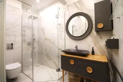 a bathroom with a sink and a shower at NEW Glamours Central Suite with Elevator in Sofia