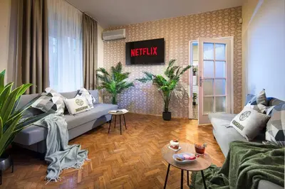 a living room with a couch and a table at Central And Spacious Home in Sofia