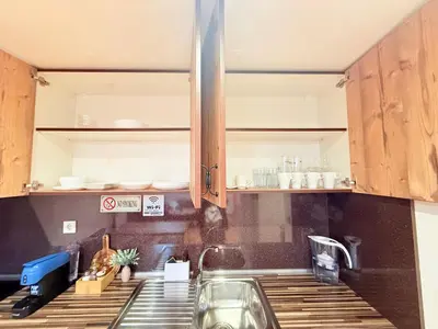 a kitchen with wooden cabinets and a sink at Center Apartments The Quiet Luxury 7 in Plovdiv