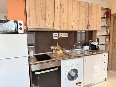 a kitchen with a washing machine and a refrigerator at Central 2 Bedroom Apartments The Quiet Luxury 8 in Plovdiv