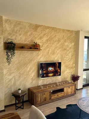 a living room with a tv on a wall at Top location unique apartment in Bansko