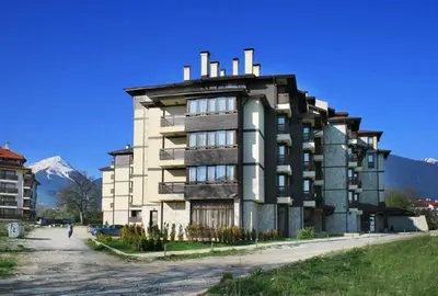 a large building in the middle of a parking lot at Top location unique apartment in Bansko