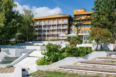 a hotel with stairs in front of a building at Balneocomplex Kamena in Velingrad