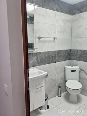 a bathroom with a toilet and a sink at Стаи за гости Куцеви in Devin