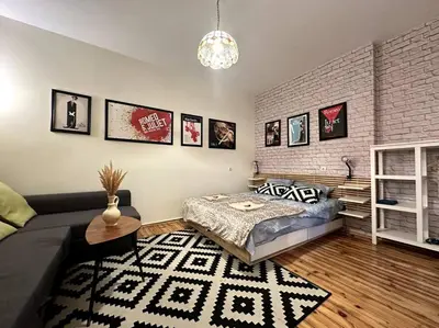 a living room with a couch and a brick wall at Cultural Retreat in Sofia in Sofia