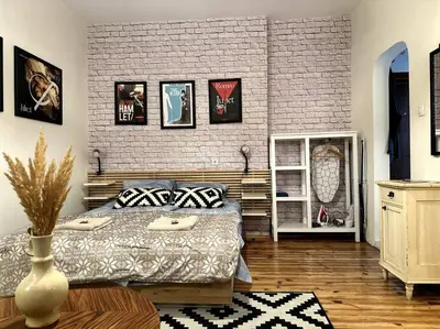 a bedroom with a bed and a brick wall at Cultural Retreat in Sofia in Sofia