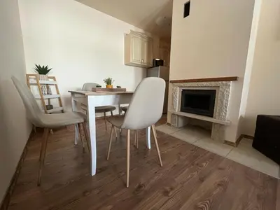 a kitchen with a table and chairs and a fireplace at 