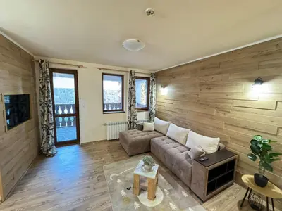 a living room with a couch and some windows at 