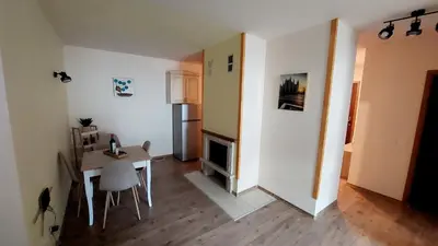 a living room with a table and a dining room at 