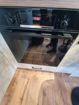 a microwave oven sitting on top of a wooden floor at Studio Todorka in Bansko