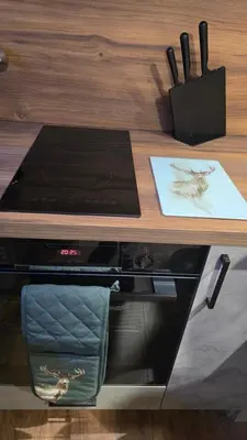 a wooden table with a counter top with a stove at Studio Todorka in Bansko
