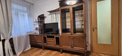 a large wooden entertainment center with a television on it at Venelin Apartment in Sofia