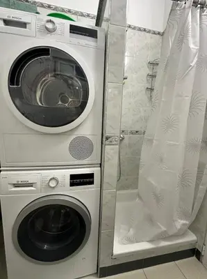 a washing machine and a washer in a bathroom at Venelin Apartment in Sofia