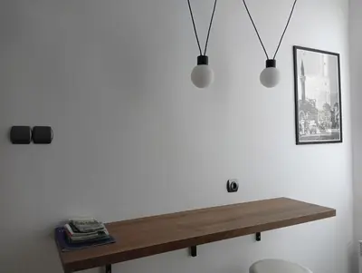 a wooden table on a white wall with two lights at My place in Sofia - Top center - 2 bedrooms - Self check-in in Sofia