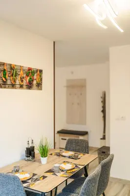 a dining room with a wooden table and chairs at Sweet Home 2 in Sandanski