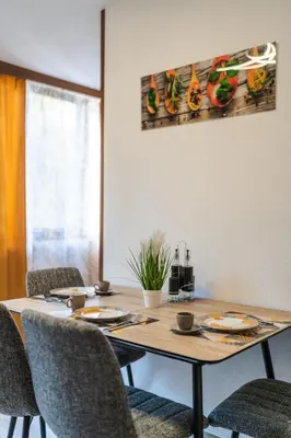 a dining room table with chairs and a wooden tableablish at Sweet Home 2 in Sandanski