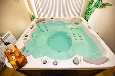 a bath tub filled with blue water in a sink at Villa Malevitsa Вила Малевица in Relyovo