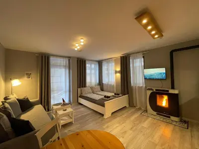 a living room with a couch and a tv at Castle Studio 203 Pamporovo in Pamporovo