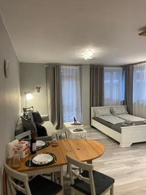 a living room with a table and a bed at Castle Studio 203 Pamporovo in Pamporovo