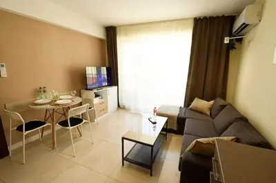 a living room with a couch and a table at INB Banishora spot 9 in Sofia