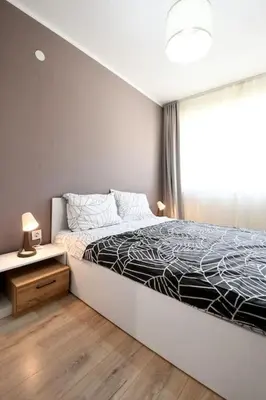 a bedroom with a large bed and a window at INB Banishora spot 9 in Sofia
