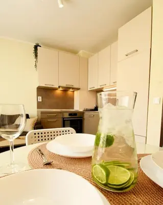 a kitchen with a table with a vase with lime at INB Banishora spot 9 in Sofia