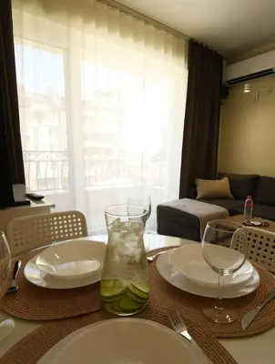 a table with plates and wine glasses on it at INB Banishora spot 9 in Sofia