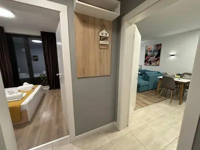 a room with a bed and a living room at Turquoise City Exotic Bliss in Sofia