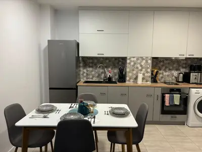 a kitchen with a table and chairs and a microwave at Turquoise City Exotic Bliss in Sofia