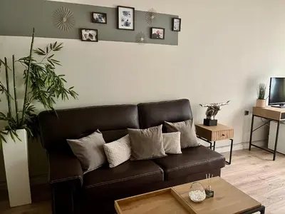 a living room with a brown leather couch at Бутиков Семеен Хотел БРИО in Velingrad