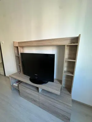 a flat screen tv on a wooden entertainment center at Lions Bridge C-E-N-T-R-A-L in Sofia