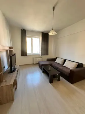 a living room with a couch and a tv at Lions Bridge C-E-N-T-R-A-L in Sofia