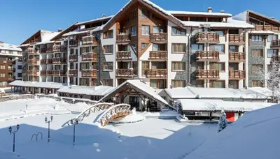 a hotel in the snow in front of a building at Belvedere 1Bedroom Apartment with Kitchen in Bansko