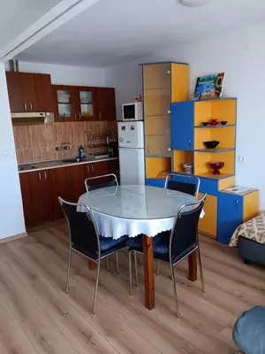 a kitchen with a table and chairs in a room at Apartment Friends in Sandanski