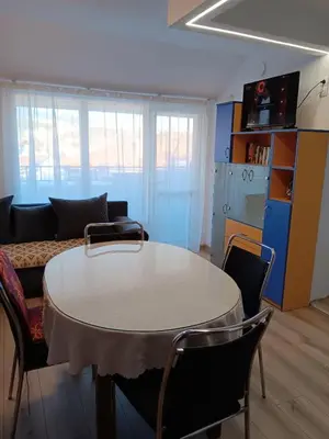 a living room with a table and a couch at Apartment Friends in Sandanski