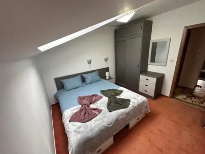 a bedroom with a bed with two towels on it at Penthouse 2 Bedroom Apartment w fireplace in Bansko