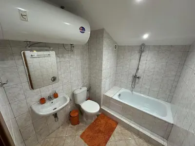 a bathroom with a tub and a toilet and a sink at Penthouse 2 Bedroom Apartment w fireplace in Bansko