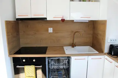 a kitchen with white cabinets and a sink and a dishwasher at One bedroom ap 602 IN RILA PARK for 6 people in Borovets